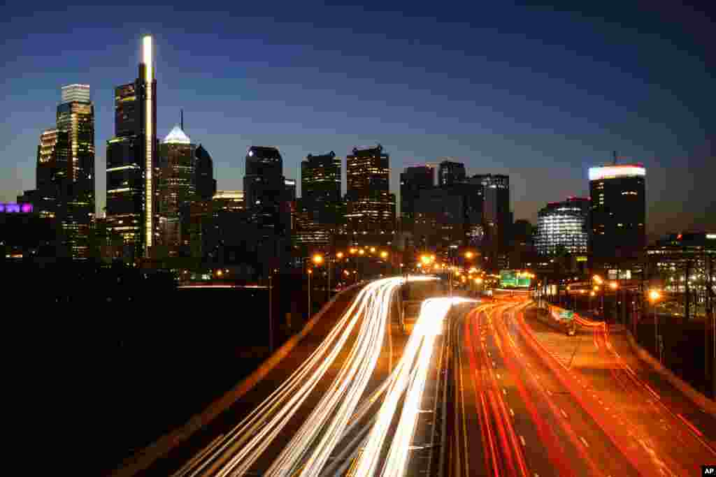 In this image made with a long exposure, motor vehicles move along Interstate 76 ahead of the Thanksgiving Day holiday in Philadelphia.