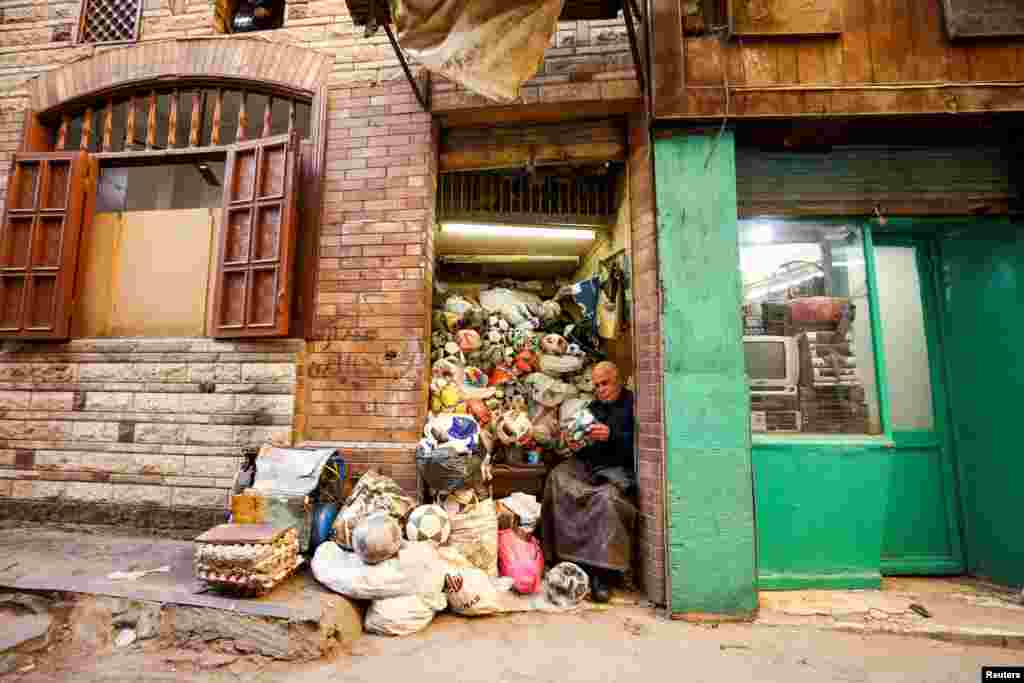 Mostafa Mahmoud, 68, fixes and makes football balls which he has been doing for 50years, in Cairo, Egypt, Nov. 30, 2022.