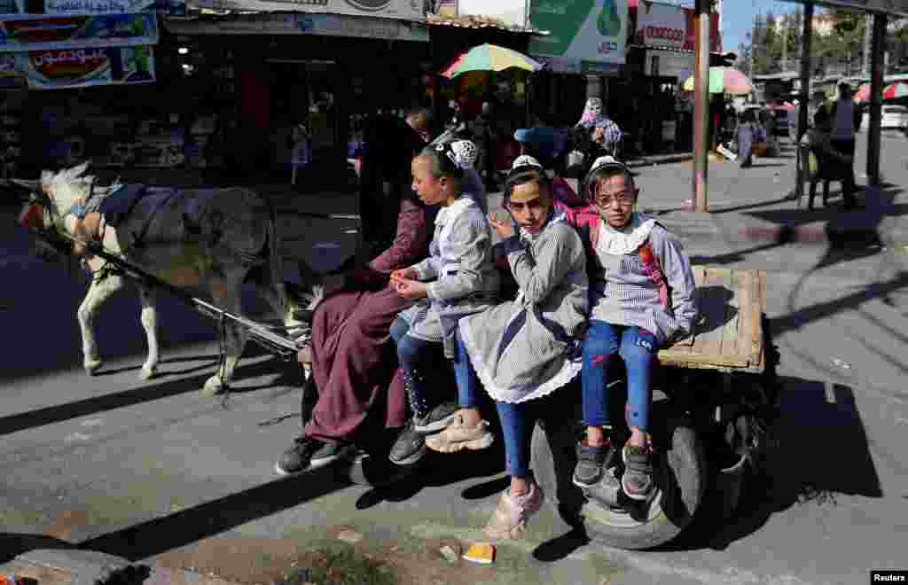 Children sit on a carriage after returning from school in Rafah in southern Gaza Strip, following a twin blast in Jerusalem.
