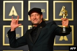 US actor Troy Kotsur shows his award for Best Actor in a Supporting Role for "CODA" during the 94th Oscars at the Dolby Theatre in Hollywood, California on March 27, 2022.