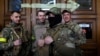 FILE - Four foreign fighters from the UK pose for a picture prior to their departure towards the front line in the east of Ukraine following the Russia's invasion, at the main train station in Lviv, western Ukraine, March 5, 2022. 