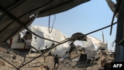 A man inspects the damage at a site targeted by an Israeli air strike a day before in Khan Younis in the southern Gaza strip on May 30, 2018.