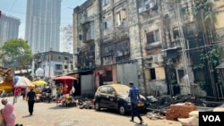 Urban planners express worry that the development will add to pressure in an area where prime residential and commercial complexes have already been built around the tenements. (Anjana Pasricha/VOA)