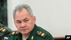 FILE: Russian Defense Minister Sergei Shoigu, right, and Head of the General Staff of the Armed Forces of Russia and First Deputy Defense Minister Valery Gerasimov listen to Russian President Vladimir Putin in Moscow, Russia, Feb. 27, 2022.