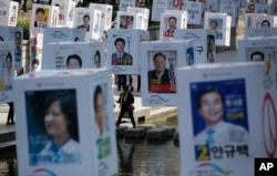 Candidates' posters for the upcoming general elections are hung on strings over the Cheonggye stream in downtown Seoul, South Korea, Monday, April 11, 2016.