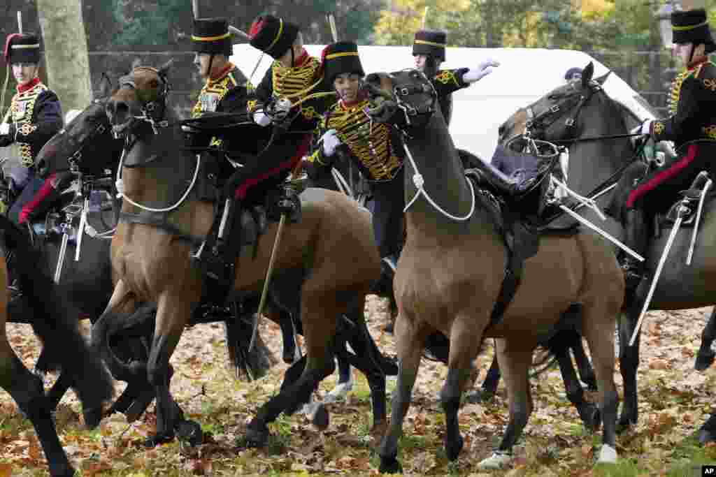 A soldier falls off a horse as the King's Troop Royal Horse Artillery arrive at Green Park to fire a 41 Gun Royal Salute to mark the 74th birthday of King Charles III in London.