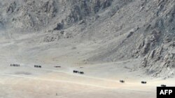 FILE - Indian soldiers walk at the foothills of a mountain range near Leh, the joint capital of the union territory of Ladakh, June 25, 2020.