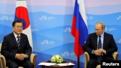 Russian President Vladimir Putin and his South Korean counterpart Moon Jae-in attend a meeting during the Eastern Economic Forum in Vladivostok, Russia, Sept. 6, 2017. 