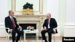 FILE - Russian President Vladimir Putin and Kazakh President Kassym-Jomart Tokayev attend a meeting on the sidelines of the Collective Security Treaty Organization (CSTO) summit at the Kremlin, May 16, 2022. (Sputnik/Anton Novoderezhkin/Pool via Reuters)