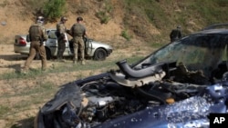 Volunteers from Belarus practice at a shooting range near Warsaw, Poland, May 20, 2022. Belarusians are among those who have answered a call by Ukrainian President Volodymyr Zelenskyy for foreign fighters to join Ukraine in its war against Russian aggress