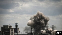 Smoke and dirt ascends after a strike at a factory in the city of Soledar at the eastern Ukranian region of Donbas on May 24, 2022, on the 90th day of the Russian invasion of Ukraine.