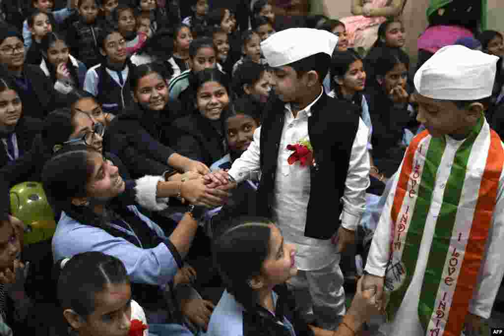 Boys dressed as India's first prime minister Jawaharlal Nehru, gesture during a celebration of Children's day on the occasion of Nehru's 133rd birth anniversary, at a school in Amritsar.