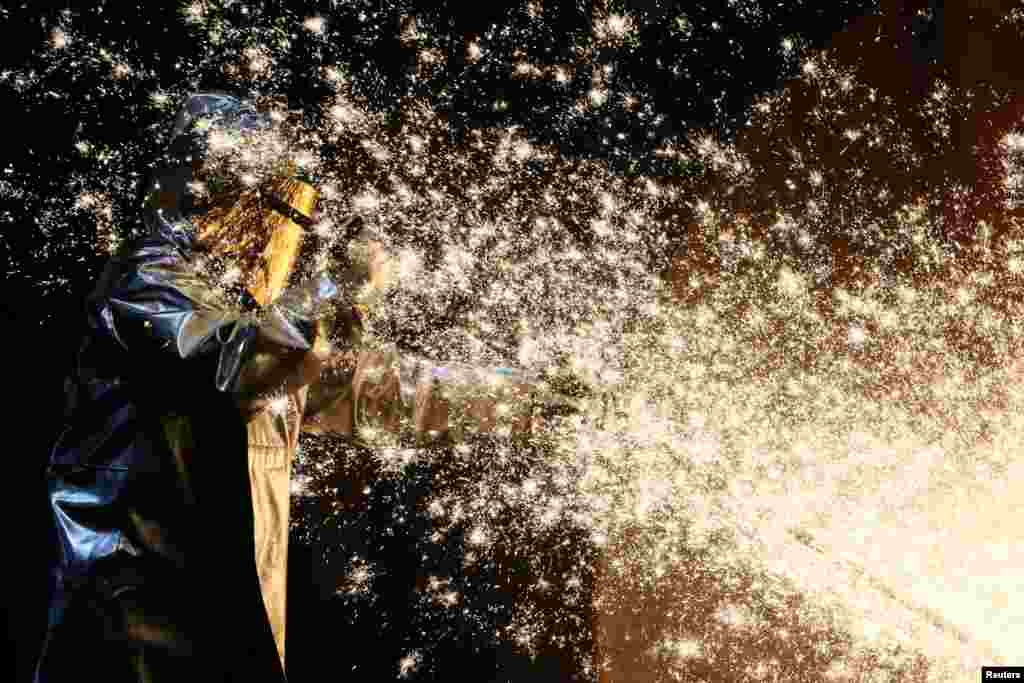 A steel worker is seen working at a ThyssenKrupp steel factory in Duisburg, western Germany.