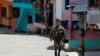 Un soldado camina por una calle en Valdivia después de que el gobierno colombiano ordenara la evacuación de los residentes que viven a lo largo del río Cauca, en Valdivia, Colombia, el 19 de mayo de 2018.