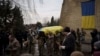 Ukrainian soldiers carry the coffin of Dmytro Kyrychenko near Kyiv, Ukraine, Dec. 23, 2022. Upon returning to Kyiv after visiting the U.S., Ukraine President Volodymyr Zelenskyy said Ukrainian forces “are working toward victory” despite Russia’s relentless attacks on the country.