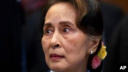 FILE - Then Myanmar's leader Aung San Suu Kyi waits to address judges of the International Court of Justice in The Hague, Netherlands, Dec. 11, 2019. 