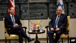 Britain's Prince William meets Israeli's President Reuven Rivlin, right, Tuesday, June 26, 2018 in Jerusalem.