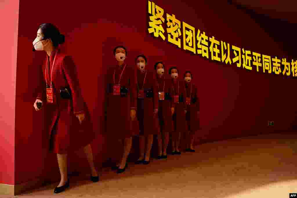 Attendants wait for visitors to the the exhibition entitled "Forging Ahead in the New Era" at the Beijing Exhibition Center in Beijing, China, ahead of the 20th Communist Party Congress meeting.