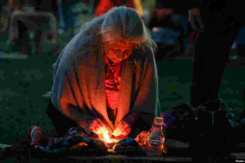 A woman prepares for sunrise ceremony, attended by Canada's Prime Minister Justin Trudeau, to mark the National Day for Truth and Reconciliation, honoring the lost children and survivors of Indigenous residential schools, at Niagara Parks power station, Ontario, Canada.
