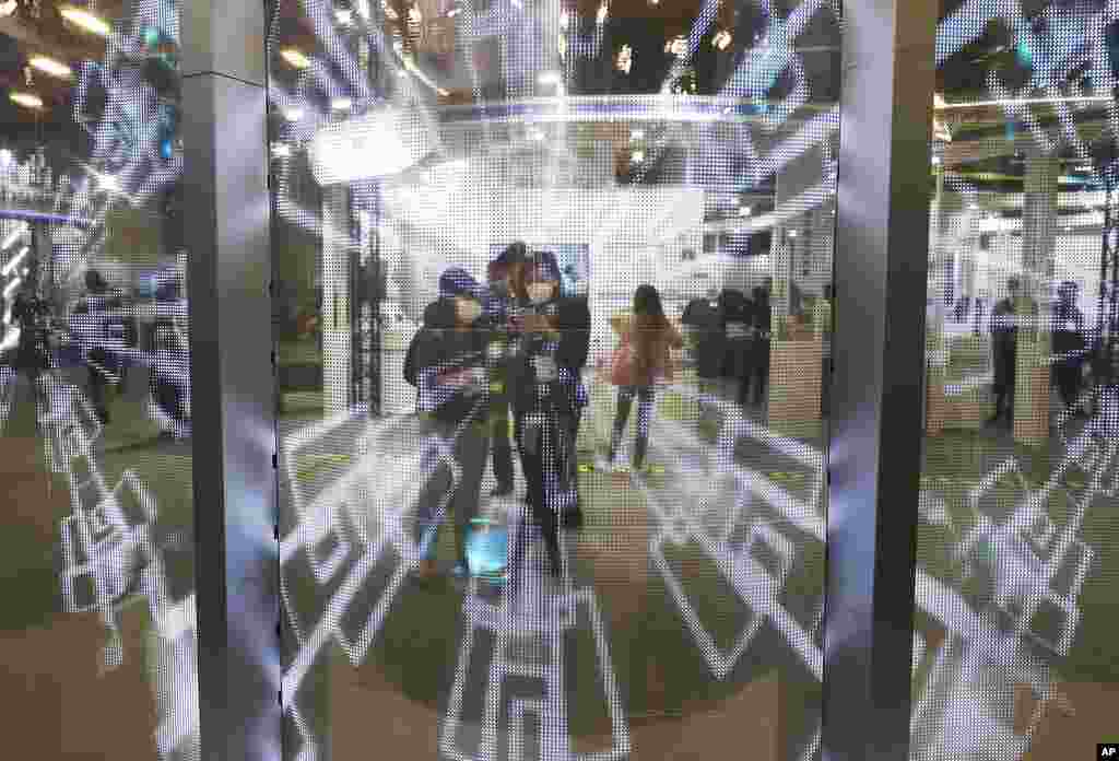 Visitors watch a transparent multi-curved interactive LED display during the Taiwan Innotech Expo at the World Trade Center in Taipei, Taiwan.