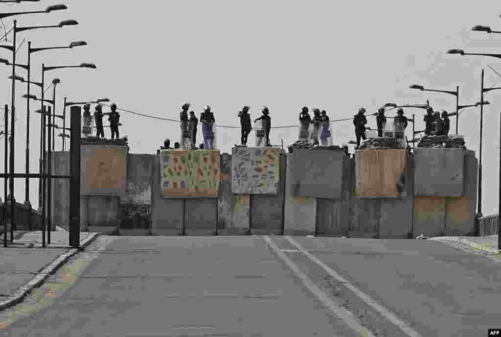 Iraqi security forces block a road leading to the Green Zone in Baghdad as lawmakers gather for their fourth attempt this year to elect a new state president and break political gridlock that has sparked deadly violence.