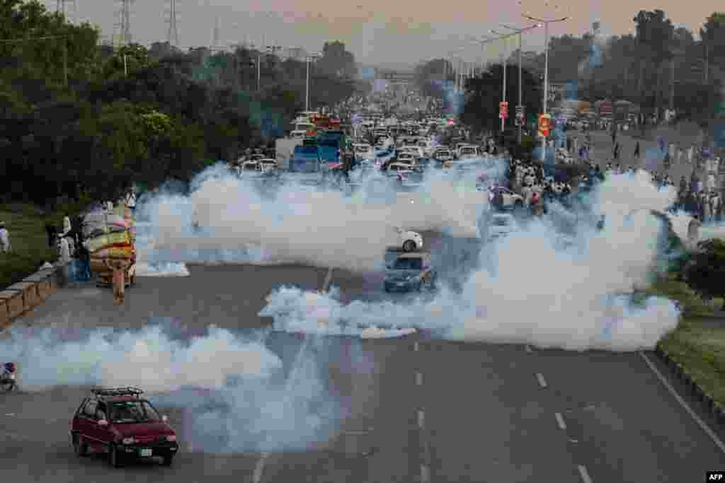 Police use tear gas to disperse protesters of Pakistan Tehreek-e-Insaf (PTI) during a demonstration against the decision to disqualify former prime minister Imran Khan running for political office, in Islamabad.