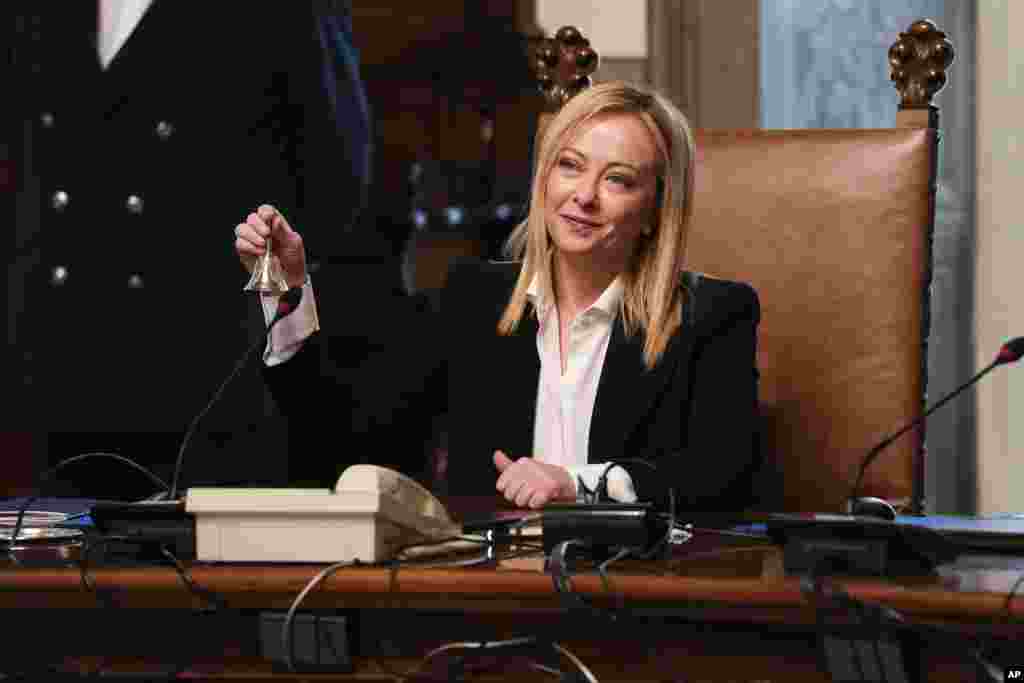 New Italian Premier Giorgia Meloni rings the cabinet minister bell during her first cabinet meeting at Chigi Palace Premier's office, in Rome.&nbsp;Giorgia Meloni, 45, whose political party with neo-fascist roots secured the most votes in Italy's national election last month, took office as the country's first far-right premier since the end of World War II. She is also the first woman to serve as premier.