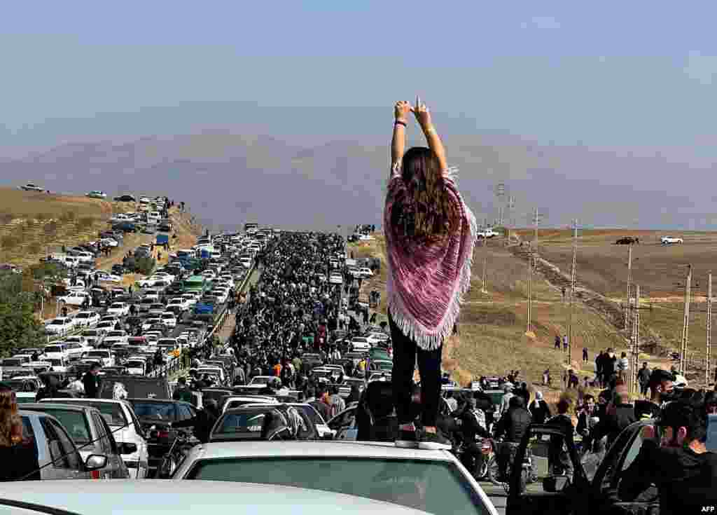 This UGC image posted on Twitter shows an unveiled woman standing on top of a vehicle as thousands make their way toward the Aichi Cemetery in Saqez, Mahsa Amini's home town in the western Iranian province of Kurdistan, to mark 40 days since her death,&nbsp;defying heightened security measures as part of a bloody crackdown on women-led protests.