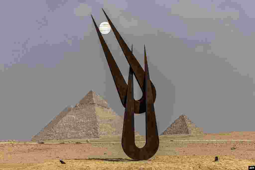 A view of the sculpture "Spirit of Hathor" by British-American sculptor, collector, art advisor, educator, and author Natalie Clark at the Giza pyramids necropolis during the second edition of the Art DÉgypte exhibition "Forever is Now".