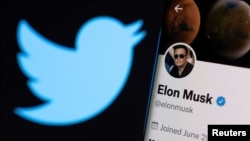 FILE - Elon Musk's twitter account is seen on a smartphone in front of the Twitter logo in this photo illustration taken, April 15, 2022. (REUTERS/Dado Ruvic/Illustration)