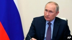 Russian President Vladimir Putin chairs a meeting on the situation in the oil and gas sector via videoconference at the Novo-Ogaryovo residence outside Moscow, Russia, Thursday, April 14, 2022. (Mikhail Klimentyev, Sputnik, Kremlin Pool Photo via AP)