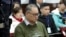 FILE - In this image taken from video and released Nov. 28, 2017, by the Intermediate People's Court of Yueyang, Taiwanese rights activist Lee Ming-Che sits during a court session at the Intermediate People's Court of Yueyang in Yueyang, in central China'