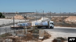A truck carrying humanitarian aid for the Gaza Strip drives at the Kerem Shalom border crossing between southern Israel and Gaza, on June 17, 2024, amid the ongoing conflict in the Palestinian territory between Israel and the militant group Hamas.