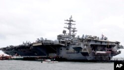 The U.S. aircraft carrier USS Ronald Reagan is anchored off Manila Bay, Philippine, for a port call Wednesday, Aug. 7, 2019. The USS Ronald Reagan is cruising in international waters in the South China Sea amid tensions in the disputed islands,…
