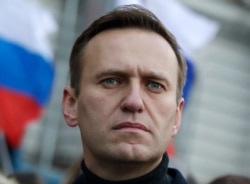 In this Feb. 29, 2020, file photo, Russian opposition activist Alexei Navalny takes part in a march in memory of opposition leader Boris Nemtsov in Moscow, Russia. Navalny has been poisoned and hospitalized on Thursday morning, Aug. 20, 2020…