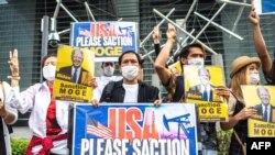 FILE - A group of Myanmar activists demonstrate with placards calling for the U.S. government to sanction Myanmar's state-run Myanma Oil and Gas Enterprise ahead of U.S. President Joe Biden's visit to Japan, in Tokyo, May 22, 2022. 