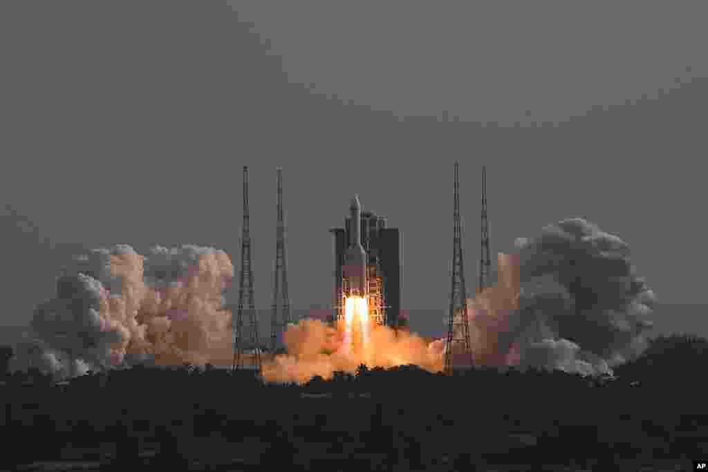 In this photo released by Xinhua News Agency, the Long March-5B Y4 carrier rocket carrying the space lab module Mengtian, blasts off from the Wenchang Satellite Launch Center in south China's Hainan Province. China has launched the third and final module to complete its permanent space station, realizing a more than decade-long endeavor to maintain a constant crewed presence in orbit.