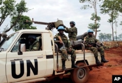 In this photo taken May 26, 2017, U.N. peacekeepers patrol outside Bria, Central African Republic. The United Nations said at the time that about 300 people had been killed and 200 wounded in the previous two weeks in Bria and a handful of other towns.