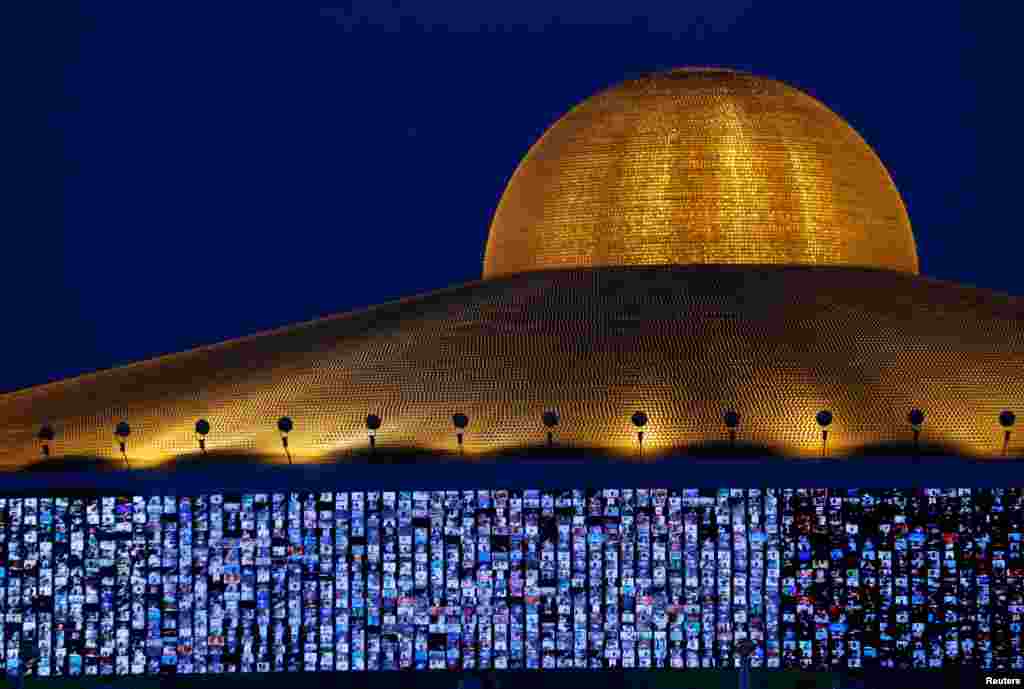 Screens show devotees gathering via Zoom application during a ceremony to commemorate Makha Bucha Day at the Wat Phra Dhammakaya temple, following the spread of the disease COVID-19 in Pathum Thani province, Thailand.