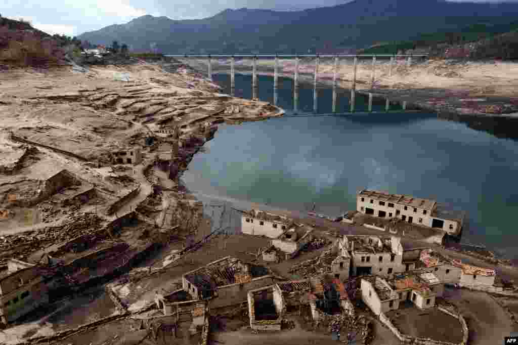 An aerial view of the usually submerged ruins of the former village of Aceredo, appearing from the Lindoso hydroelectric plant reservoir due to the low water level, near Lobios, Ourense province, northwestern Spain.