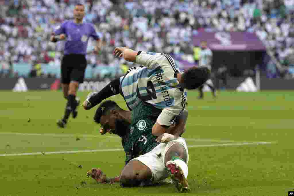 Saudi Arabia's Firas Al-Buraikan and Argentina's Nicolas Tagliafico challenge for the ball during the World Cup group C soccer match between Argentina and Saudi Arabia at the Lusail Stadium in Lusail, Qatar.