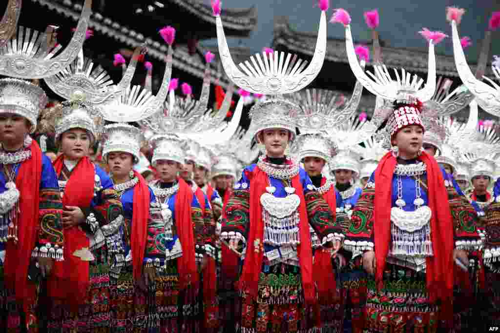 Women of the Miao ethnic minority, dressed in traditional costumes, take part in the celebration of the Kuzang Festival in Leishan county, in China's southwestern Guizhou province, Nov. 19, 2022.