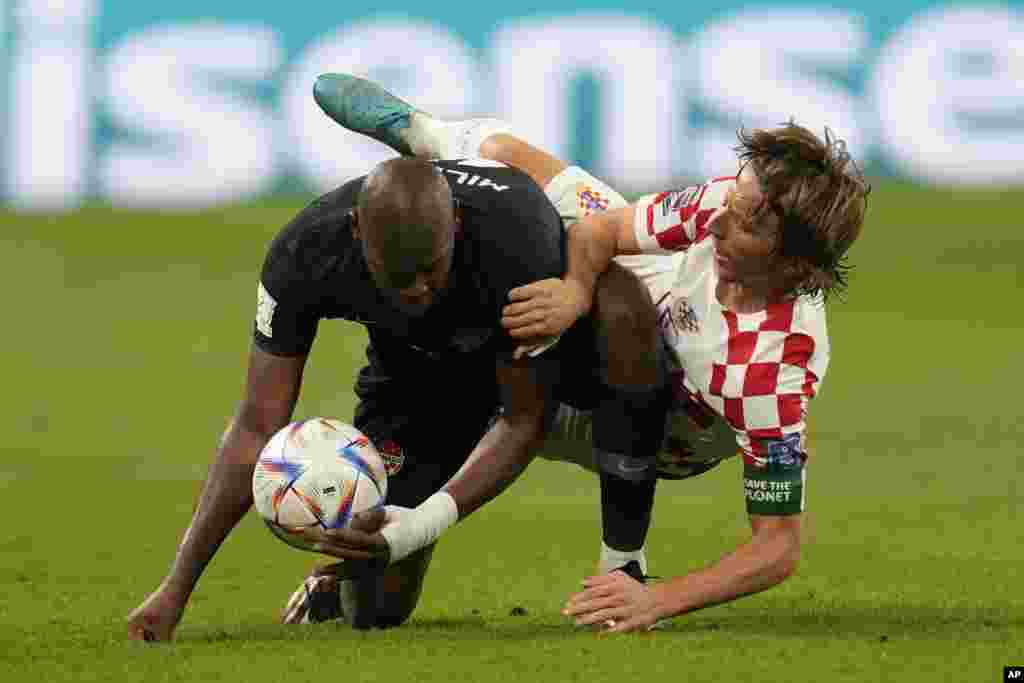 Croatia's Luka Modric fights for the ball with Canada's Kamal Miller during the World Cup group F soccer match between Croatia and Canada, at the Khalifa International Stadium in Doha, Qatar.