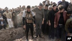 Syrian Kurds attend a funeral of people killed in Turkish airstrikes in the village of Al Malikiyah , northern Syria, Nov. 21, 2022. 