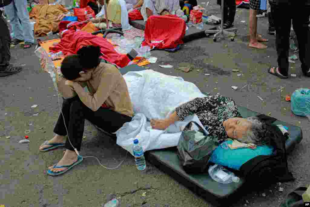 Earthquake survivors are treated outside of a hospital in Cianjur, West Java, Indonesia.&nbsp;A powerful earthquake has toppled buildings on the country's densely populated main island, killing at least 162 people and injuring hundreds.&nbsp;