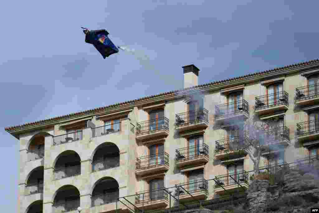 Spanish base-jumper Dani Roman, wearing a wingsuit, crosses the main arc of the New Bridge in Ronda.