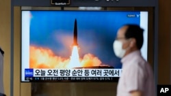 FILE: A TV screen showing a news program reporting about Sunday's North Korean missile launch with file image, is seen at a train station in Seoul, South Korea, June 5, 2022. 
