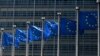 FILE - Flags fly outside the European Commission building in Brussels, June 16, 2022.
