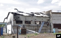This frame from a video shows a destroyed barracks at a prison in Olenivka, in an area controlled by Russian-backed separatist forces, eastern Ukraine, July 29, 2022. Russia and Ukraine accused each other Friday of shelling the prison.