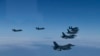 In this photo provided by South Korea Defense Ministry, U.S. and South Korea Air Force fighter jets fly in formation during a joint drill on Tuesday, June, 7, 2022. The South Korean and U.S. militaries flew 20 fighter jets over South Korea's western sea T
